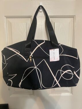 Stylish Black Travel Tote with Cream Abstract Script